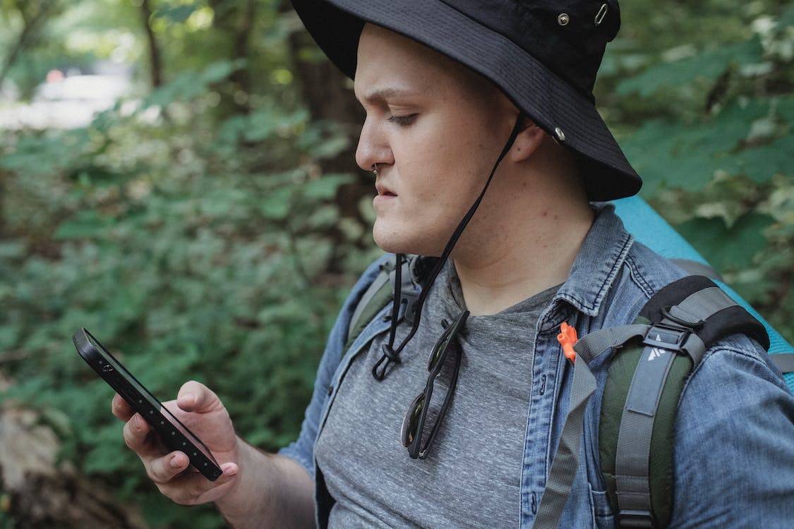 a backpacker using a phone 