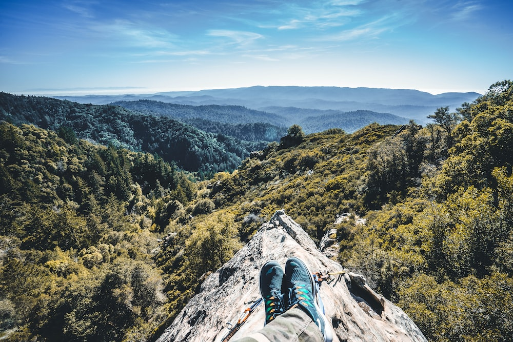 A person sitting on a cliff.